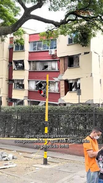 Residential building with a severely damaged facade, declared a total loss